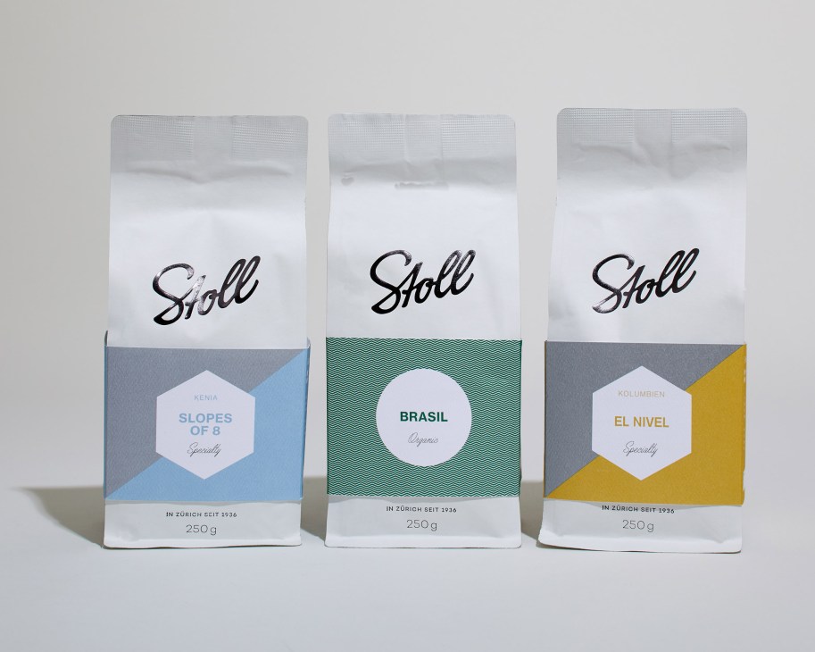 Three Stoll Kaffee coffee packages with white tops and colored lower sections in blue, green, and yellow.