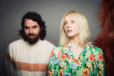 Two musicians from the band Lump posing against a gray background.