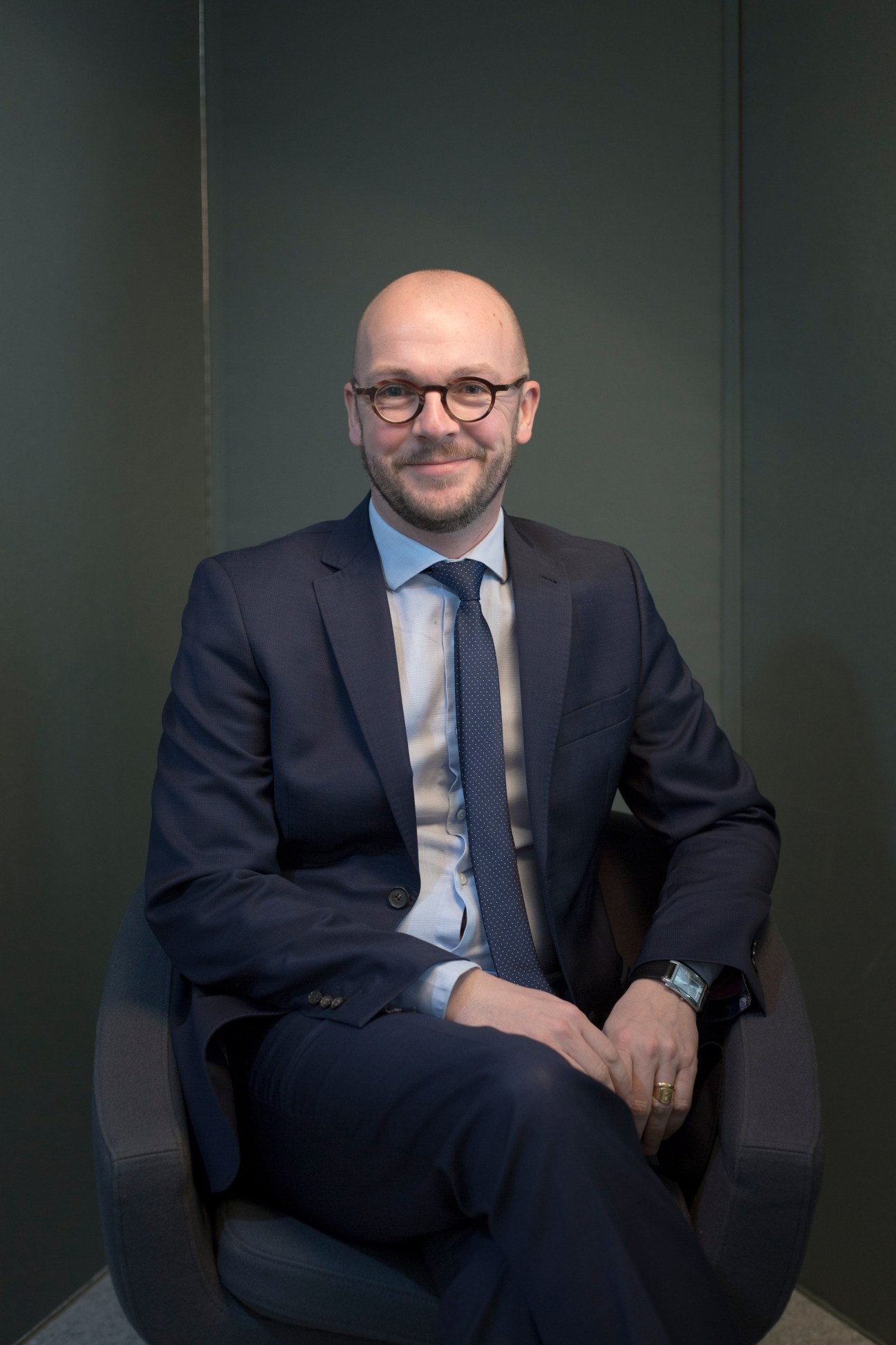 Portrait of Ronan Vaspart, Director of Mipim, sitting in business attire against a green background.