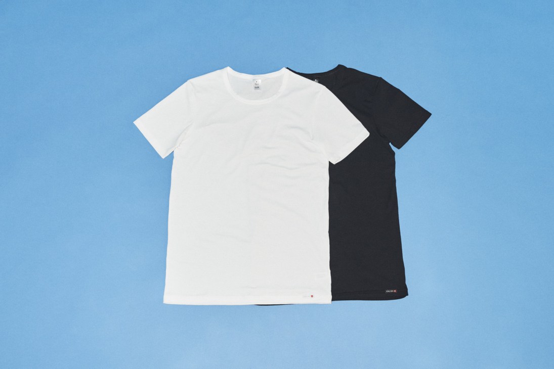White and black t-shirts displayed on a blue background
