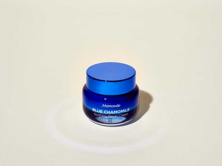 Mamonde Blue Chamomile Soothing Repair Cream in a blue jar against a neutral background.