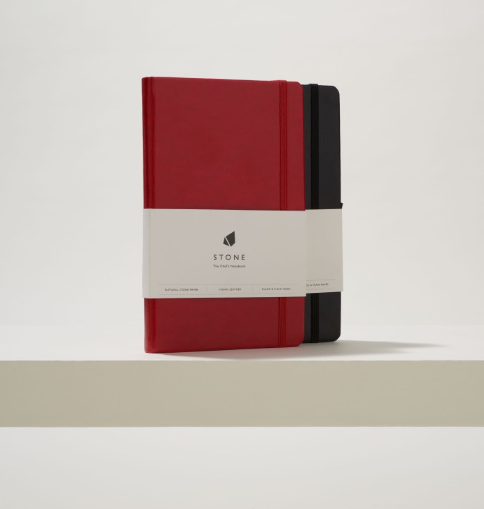 Stone brand chef's notebook with red and black vegan leather covers displayed side by side.