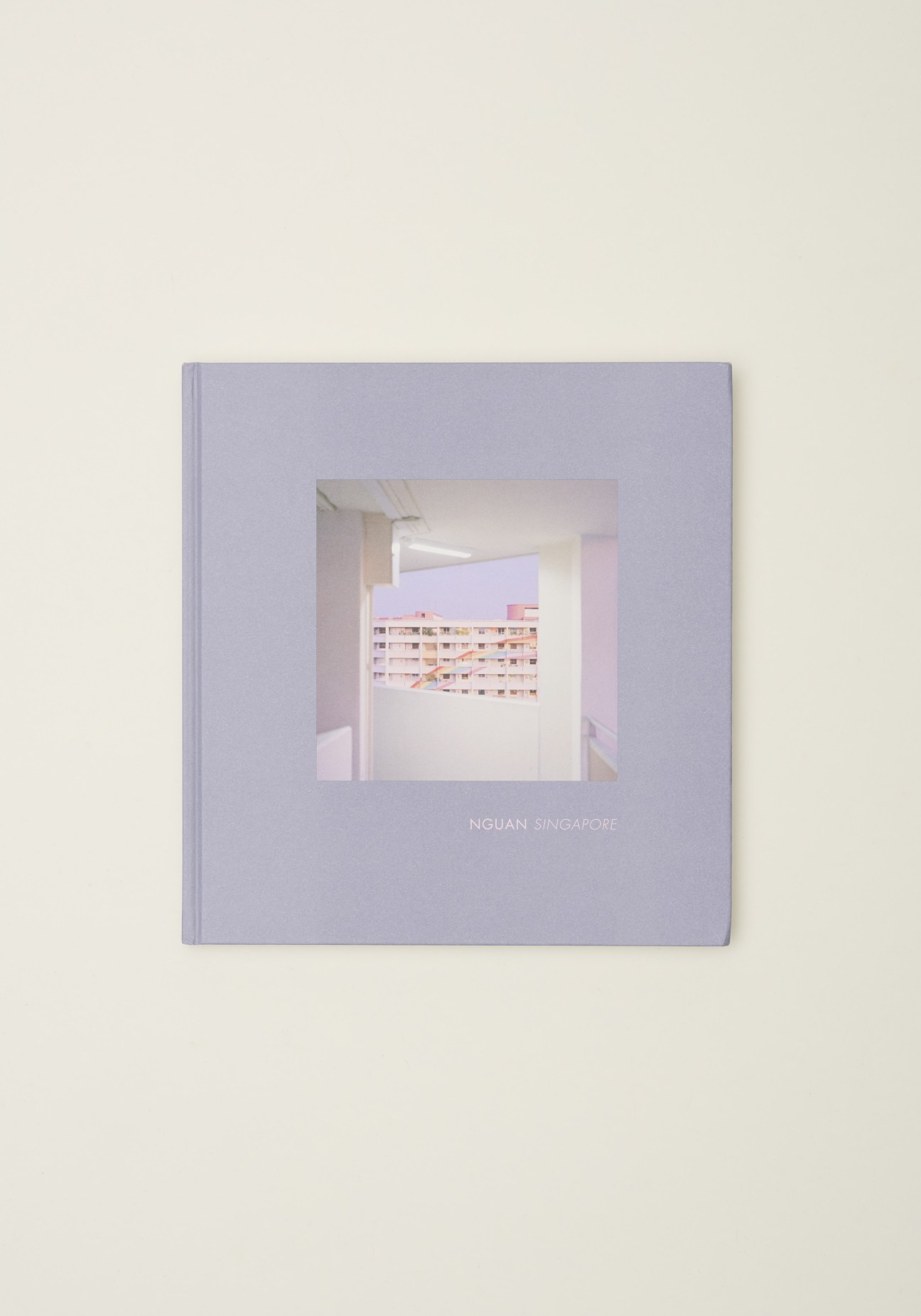 Cover of Singapore photography book by Nguan showing serene architectural interior with pastel tones