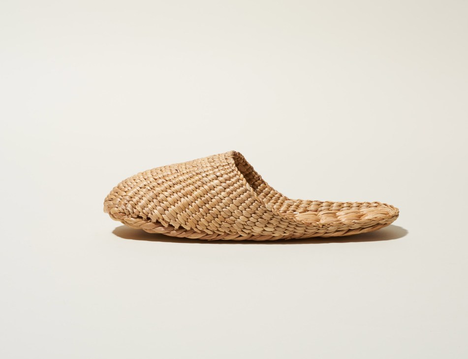 Woven rattan slipper with bamboo handle by Wed71, displayed against a neutral background.