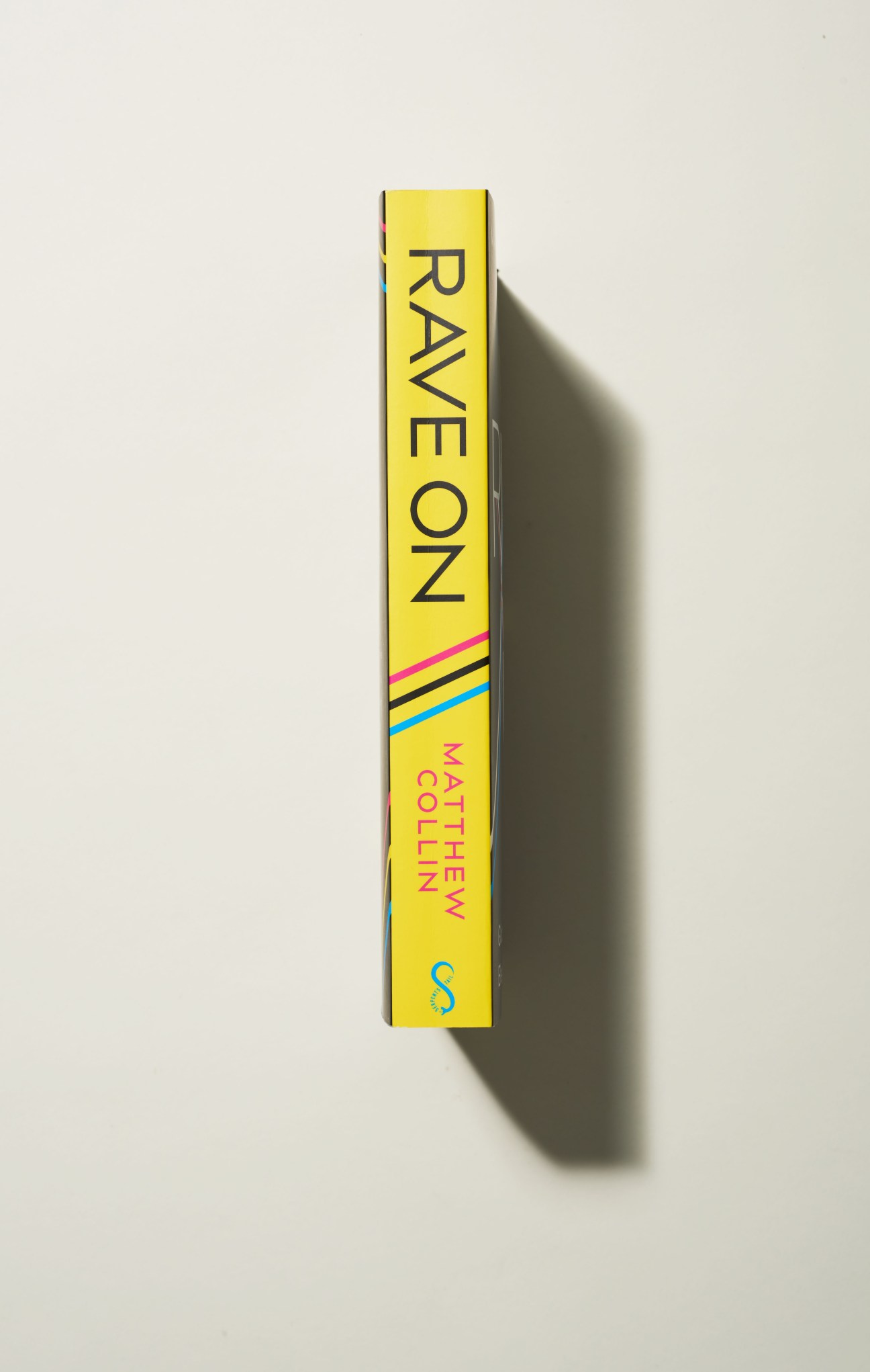 Yellow book spine showing 'Rave On' by Matthew Collin with colorful striped design details.