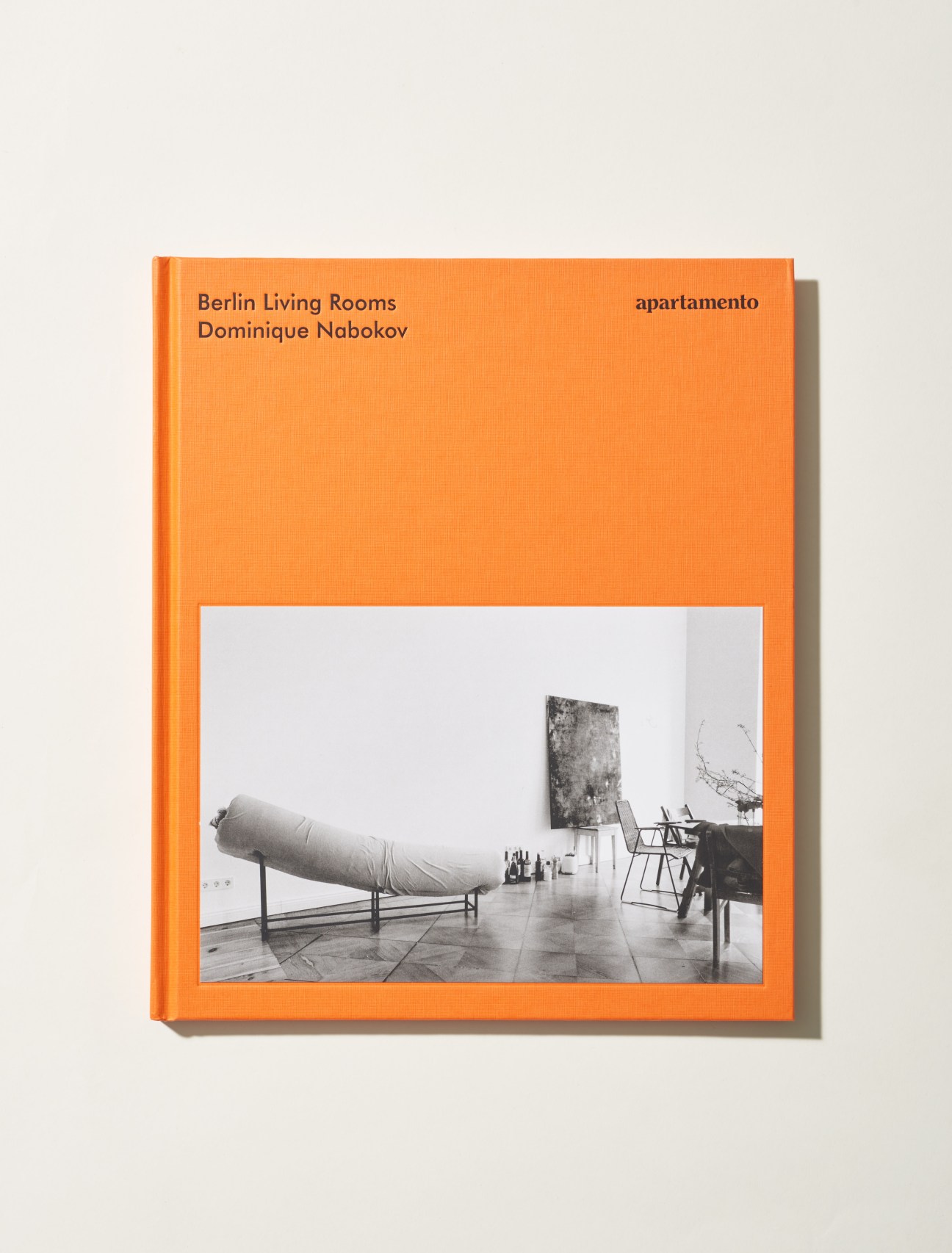 Berlin Living Rooms book by Dominique Nabokov with orange cover showing minimalist interior photograph.