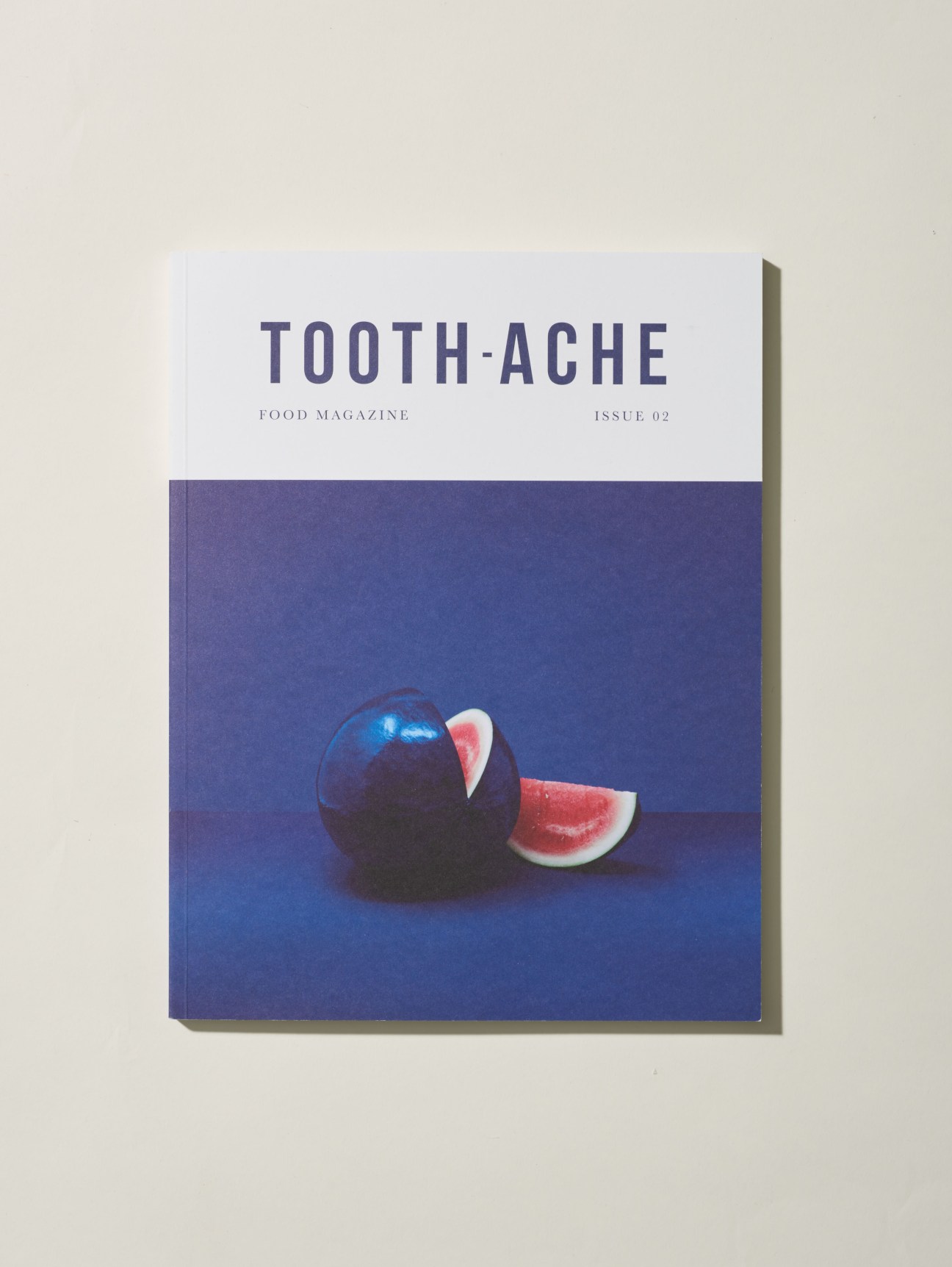 Cover of Tooth-Ache food magazine Issue 02 featuring a black sphere and watermelon slices on blue background.