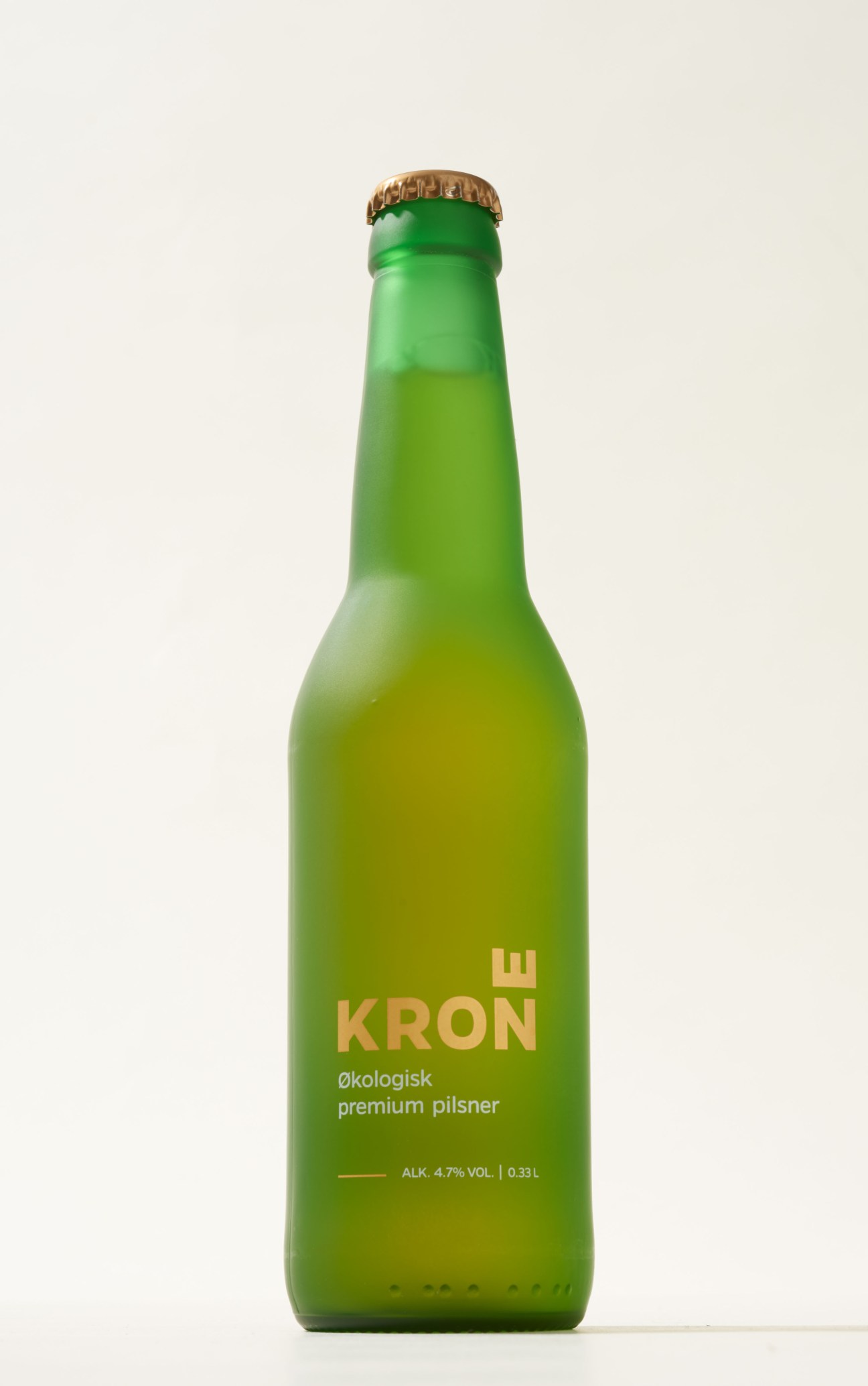 Krone organic premium pilsner beer bottle with gold lettering on green glass.