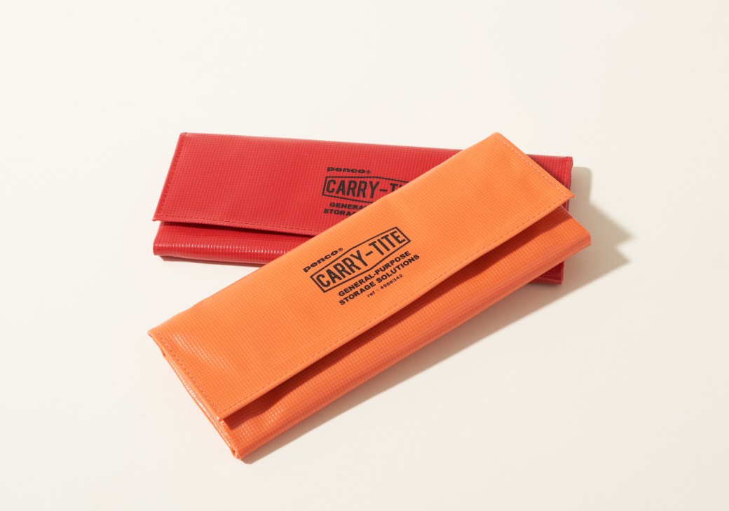 Two Penco waterproof PVC tarpaulin storage cases in orange and red with Velcro seals.