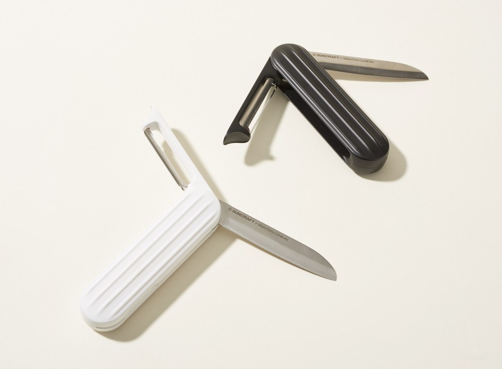 Two Suncraft multi-tool peelers with stainless steel blades and ribbed handles in white and black.