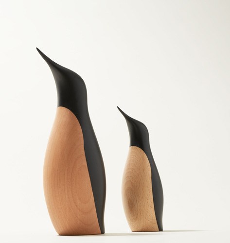Two wooden penguin sculptures in different sizes with natural beech wood bodies and black hand-painted backs.