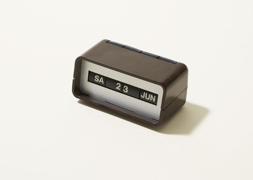 Vintage Arlac desk calendar in brown with rolling mechanism showing day, date and month.