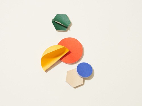 Colorful sticky notes in various shapes including hexagon, circle, and curved forms in green, yellow, coral, and blue.
