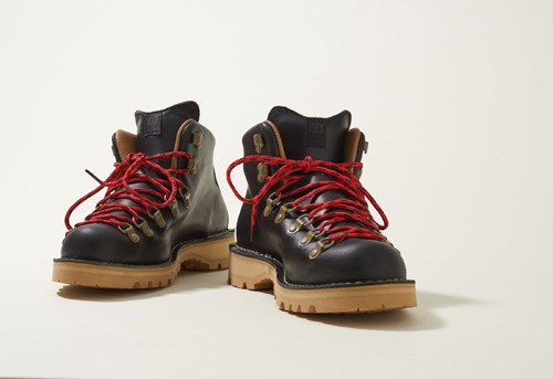 Pair of black leather hiking boots with red laces and tan soles by Danner x Topo Designs.