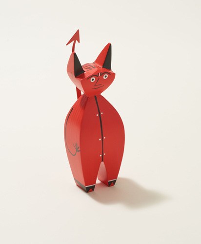 Red wooden devil figurine with horns and tail designed by Alexander Girard for Vitra.