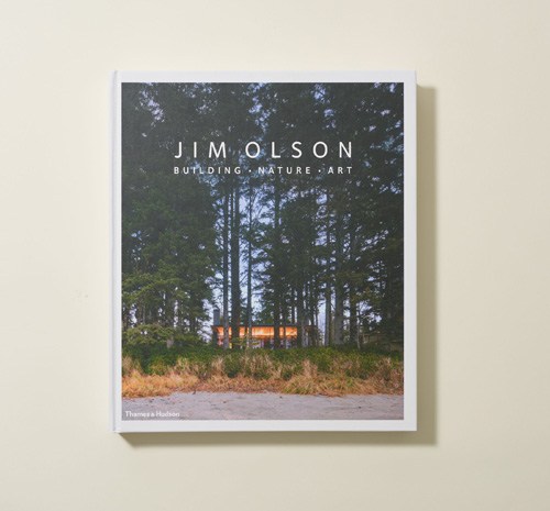 Jim Olson's 'Building, Nature, Art' book cover featuring a modern wooden cabin in a forest clearing.