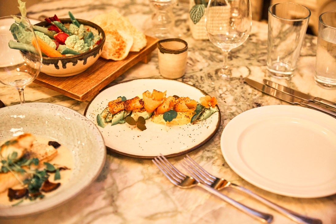 Elegant plated dish with roasted vegetables and garnish at The Ned restaurant in London.
