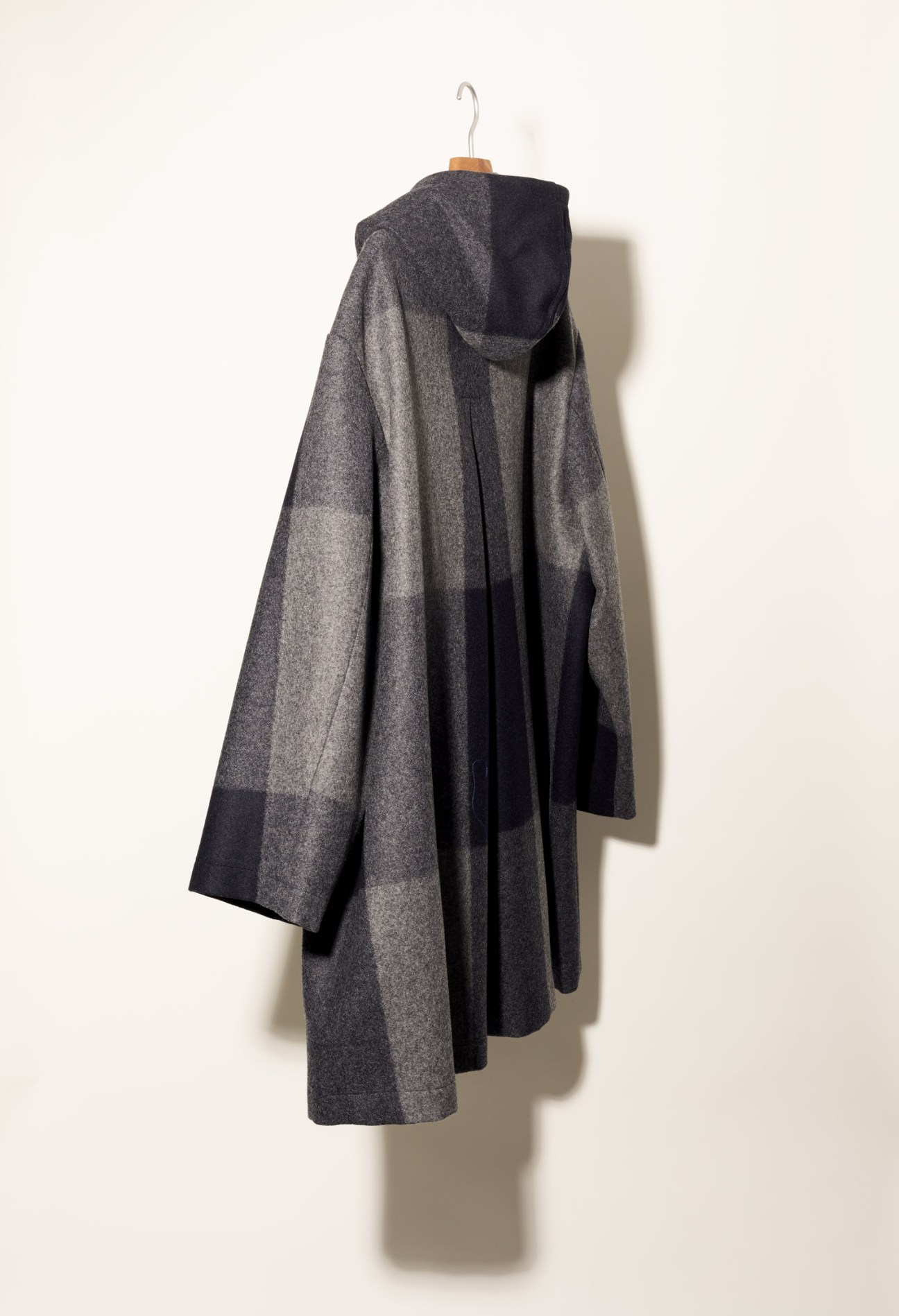 Cini checked overcoat in brown pattern hanging on wooden hanger