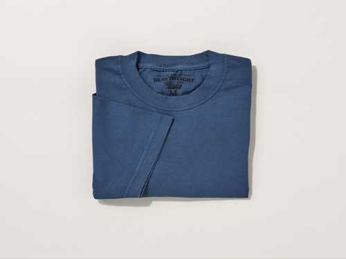 Heavyweight Collections Pro-Fit T-shirt in blue folded on a neutral background.