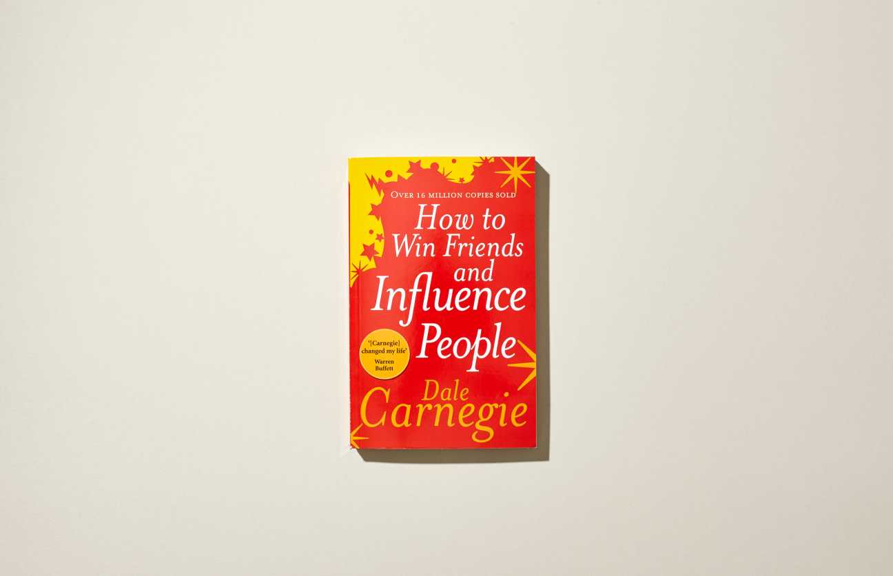 Book cover of "How to Win Friends and Influence People" by Dale Carnegie with red and yellow design.