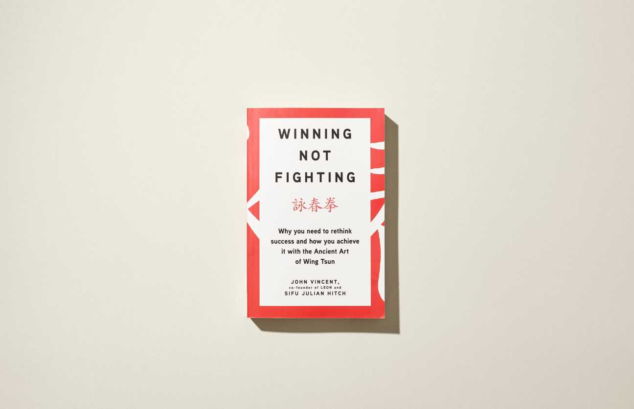Book cover of Winning Not Fighting by John Vincent and Sifu Julian Hitch with red border and white background.