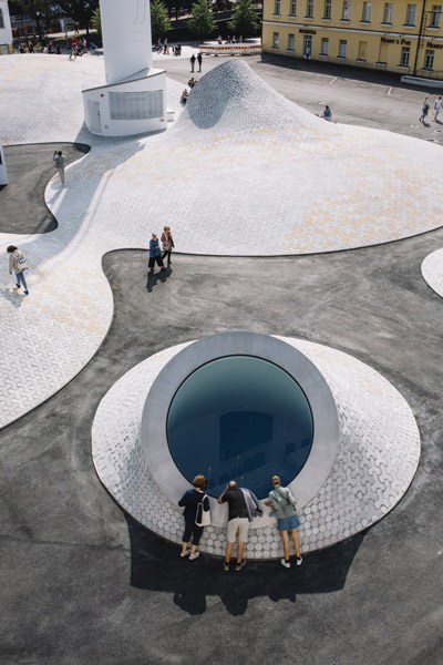 Aerial view of Amos Rex museum in Helsinki with white concrete structures protruding from Lasipalatsi Square.