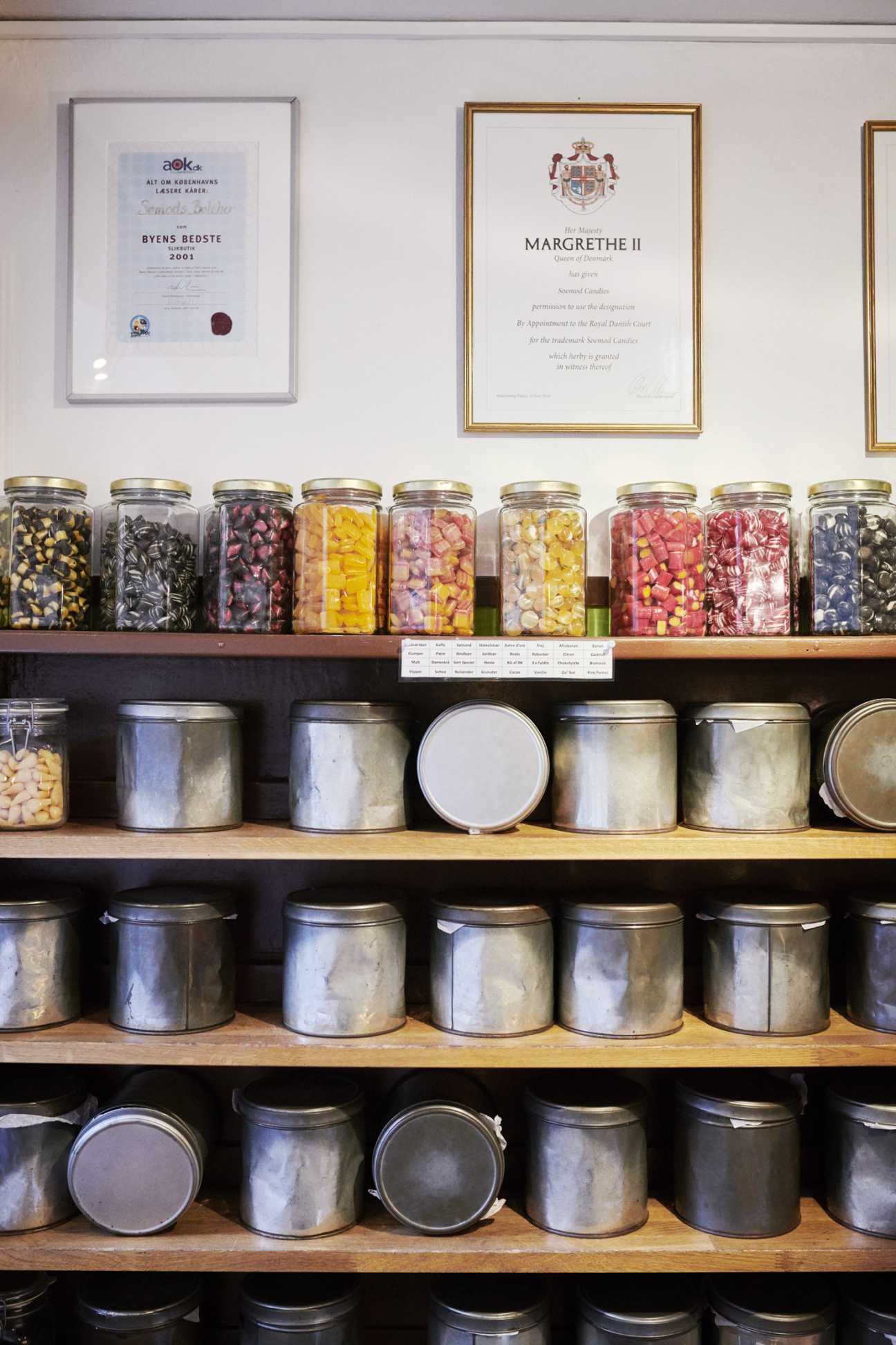 Sømods Bolcher sweet shop with colourful boiled sweets displayed in glass jars on wooden shelves.