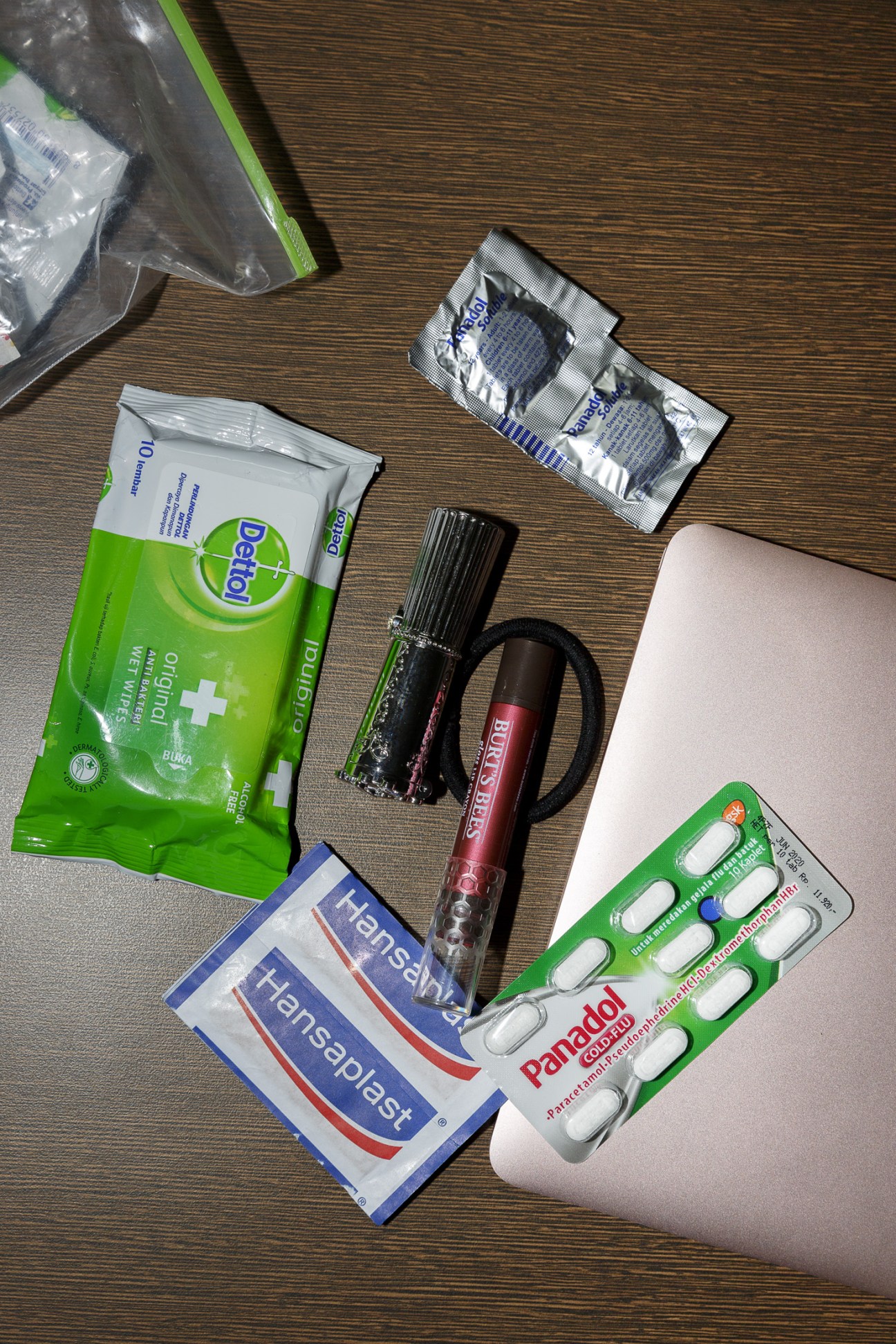Noni Purnomo's personal survival kit including antibacterial wipes, lipstick, hair band, plasters, and painkillers.