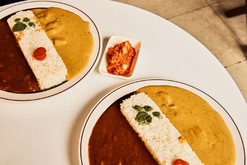 Two bowls of curry featuring prawn and bacon curry at Shiba Curry restaurant in Gwangju.