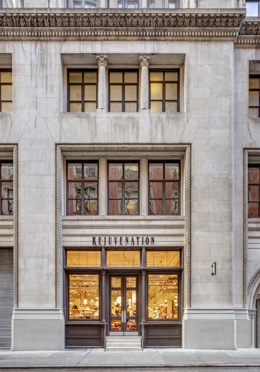 Rejuvenation storefront on West 20th Street in New York with illuminated windows displaying home goods and furnishings.