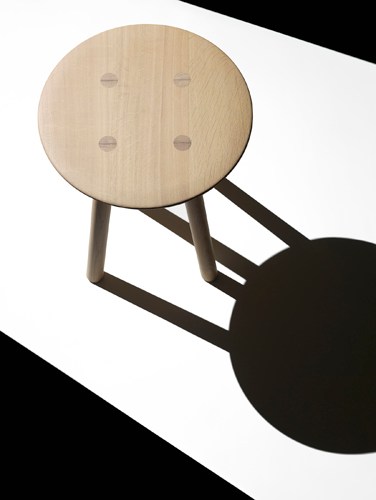 Foster + Partners' Ovo timber stool by Benchmark with light wood seat and angular legs.