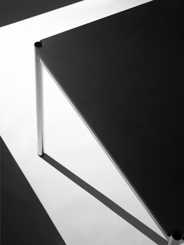 USM modular table system with chrome-plated steel and brass frame in minimalist geometric design.