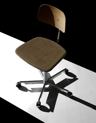 The Kevi chair by Jørgen Rasmussen with curved wooden backrest, corduroy seat, and black swivel base.