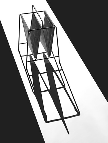 Steel mesh magazine holder by Fritz Hansen with geometric frame design.