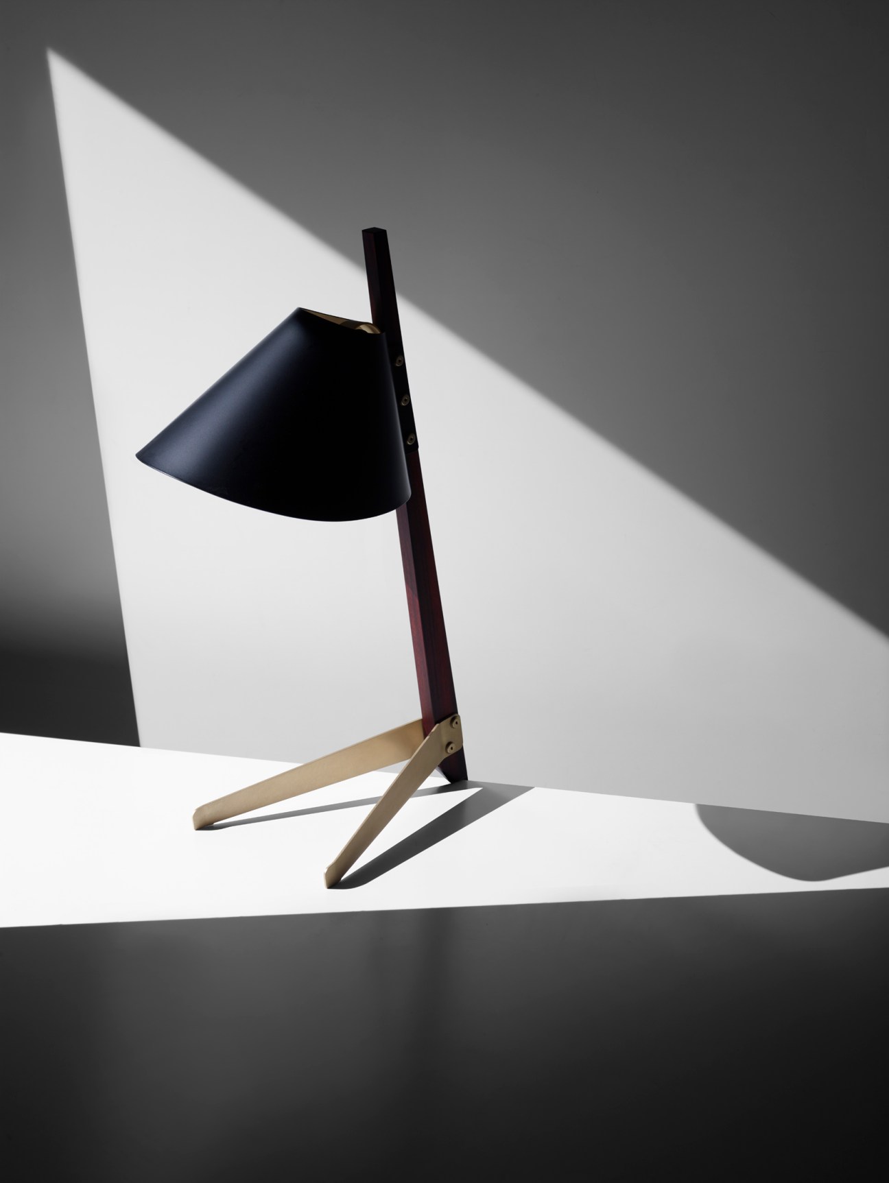 Billy TL desk lamp by Ilse Crawford with black cone shade and dark wooden stem on brass base.