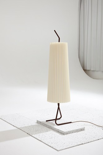 Fliegenbein SL lamp with cream pleated shade and curved dark metal base on white surface.