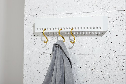 So-Hook wall rack by Nomess with S-hooks and shelf holding a gray garment on a white speckled wall.