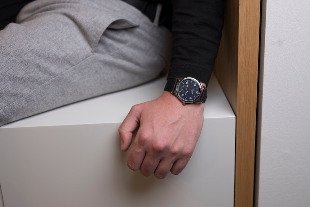 Nomos Glashütte Club Campus watch with rose-gold hands and textile strap worn on wrist.