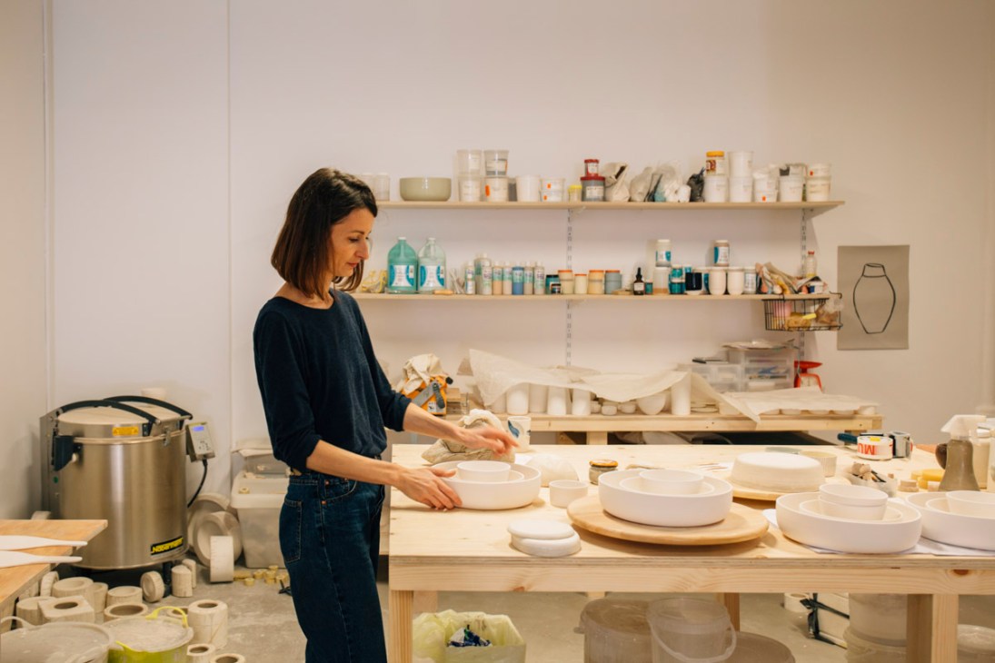 Miriam Cernuda working with ceramic bowls in her Barcelona workshop studio.