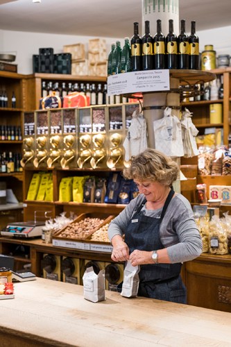 Interior of H Schwarzenbach spice shop in Zurich showing wooden shelves lined with jars and containers