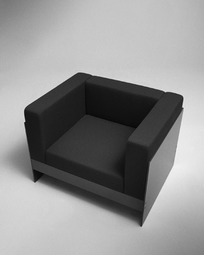 Black upholstered armchair with simple geometric form and clean lines in a minimalist style.