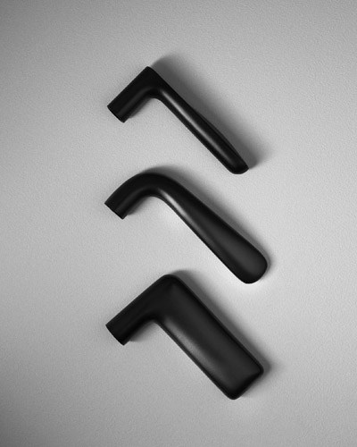 Three black door handles with soft-rebound release mechanism designed by Turn.