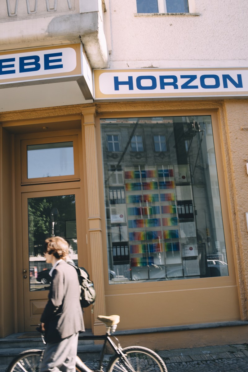 Woman walking past Moebel Horzon furniture shop storefront in Berlin