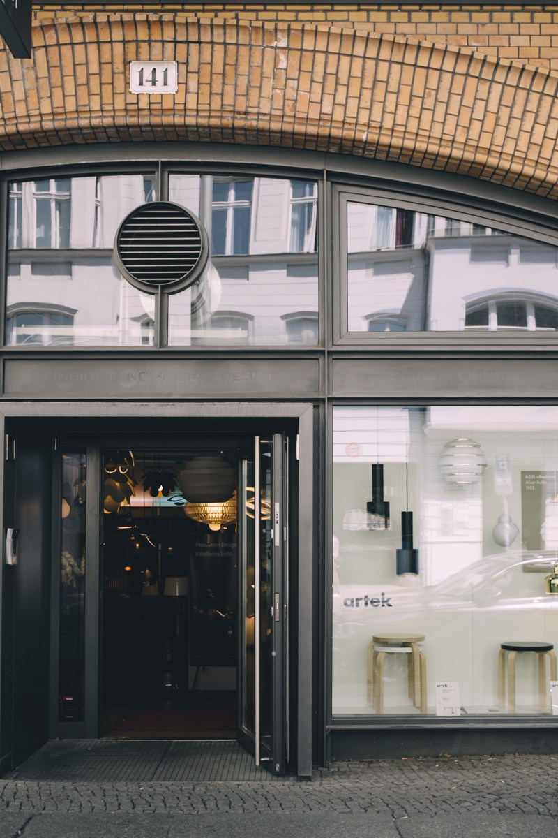 Mittelicht lighting shop storefront with pendant and table lamps displayed in windows.