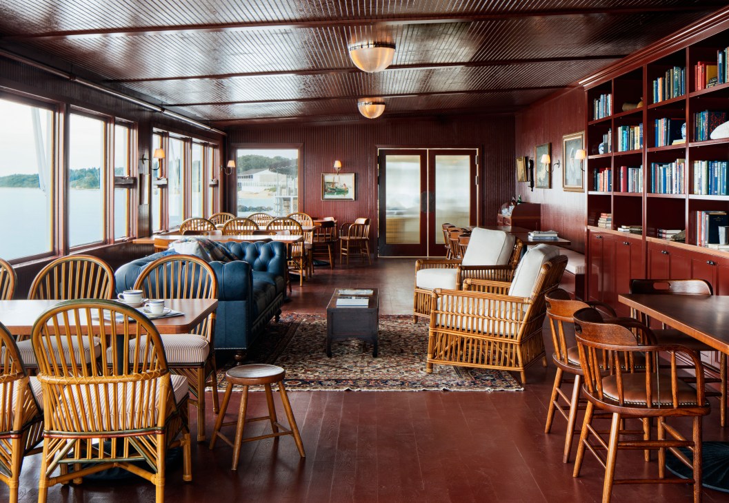 Interior library lounge with bookshelves, comfortable seating, and warm lighting at Sound View hotel.