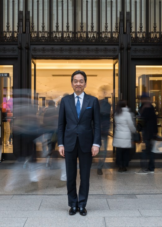 Toshihiko Sugie, president and CEO of Isetan department store, stands in a navy suit outside Isetan's Shinjuku location.