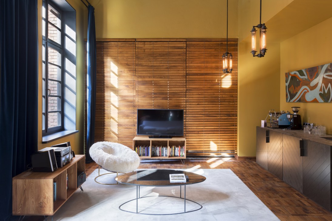 Interior view of Stamba Hotel showing industrial machinery integrated into modern hotel design