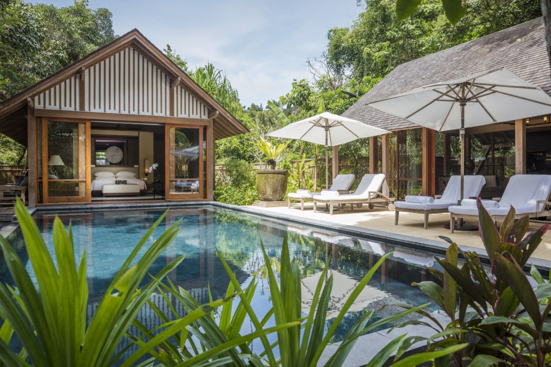 The Datai luxury resort villa with teak architecture, private pool, and jungle surroundings in Malaysia.