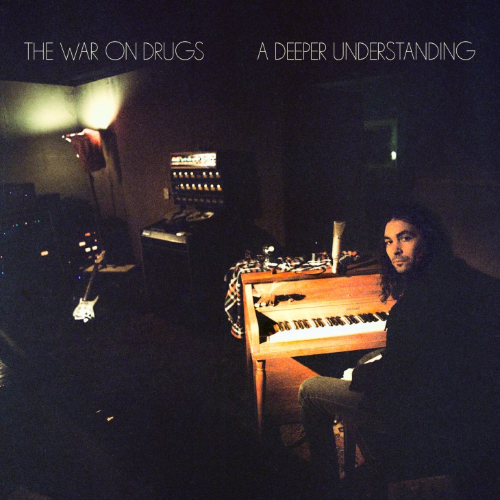The War on Drugs album cover 'A Deeper Understanding' featuring band members with synthesizers in a darkly lit studio.