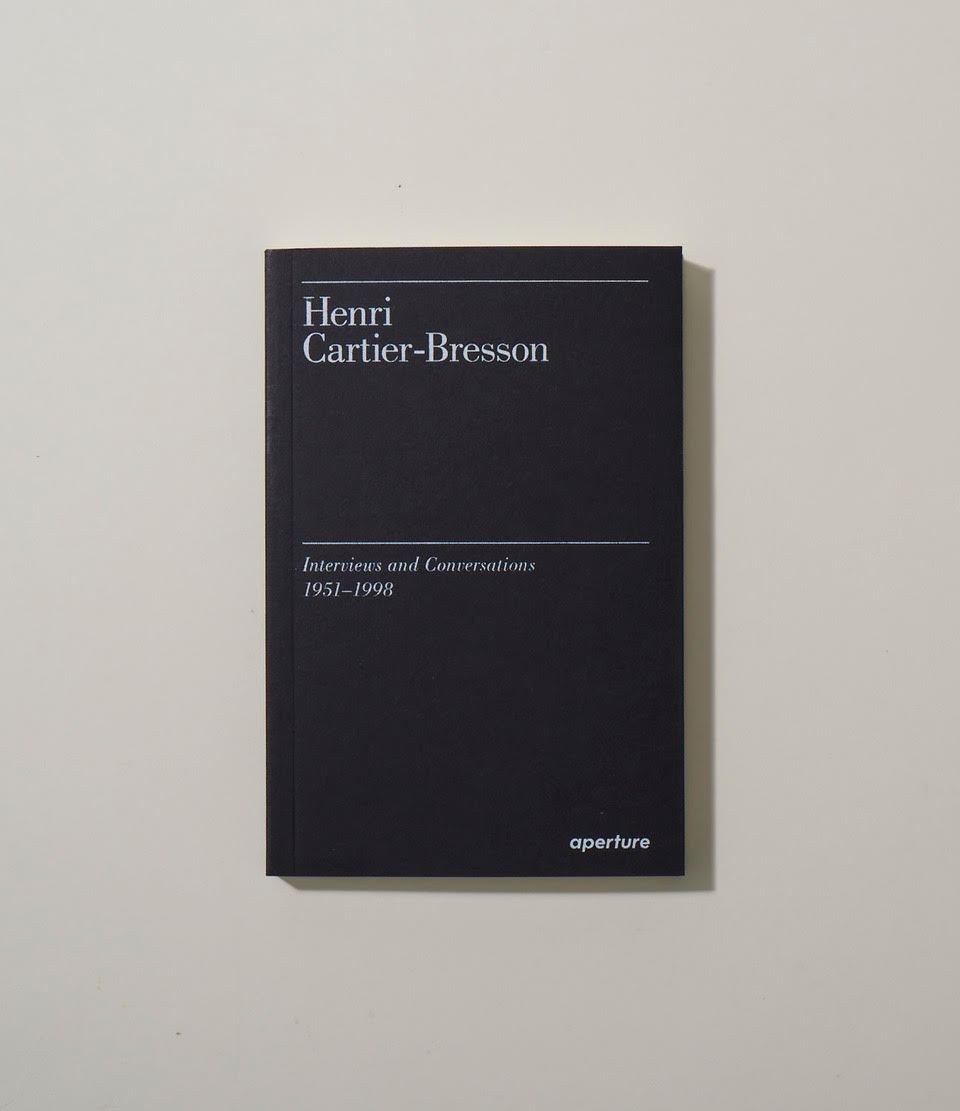 Black book cover with white text reading Henri Cartier-Bresson Interviews and Conversations 1951-1998, published by Aperture.